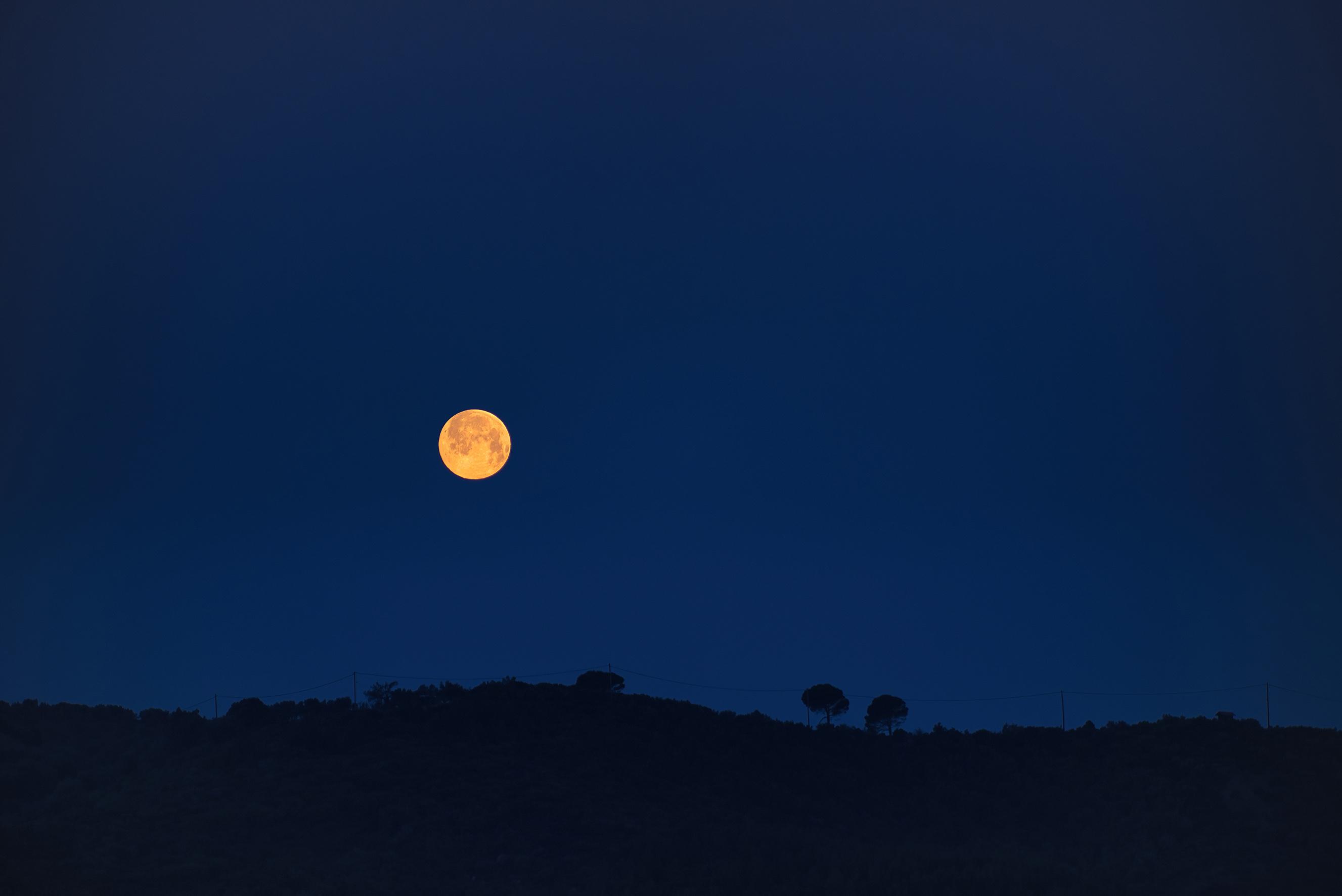 full moon over an island in the Aegean Sea, Greece